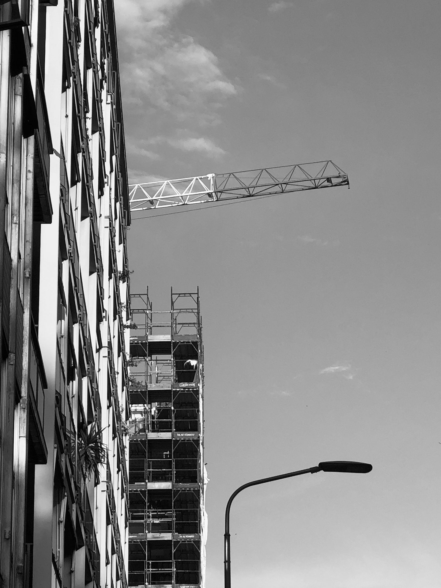 A black and white photo of a building under construction